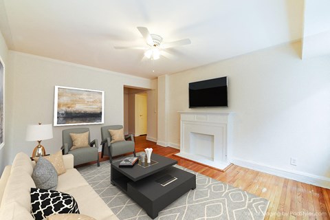 living area with sofa, coffee table hardwood floors and ceiling fan at 4031 davis place apartments in washington dc