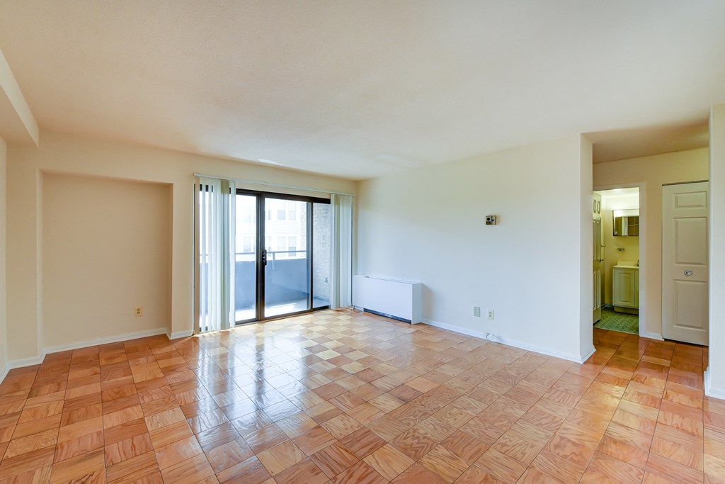 vacant living area with glass doors to balcony at twin oaks apartments columbia heights washington dc