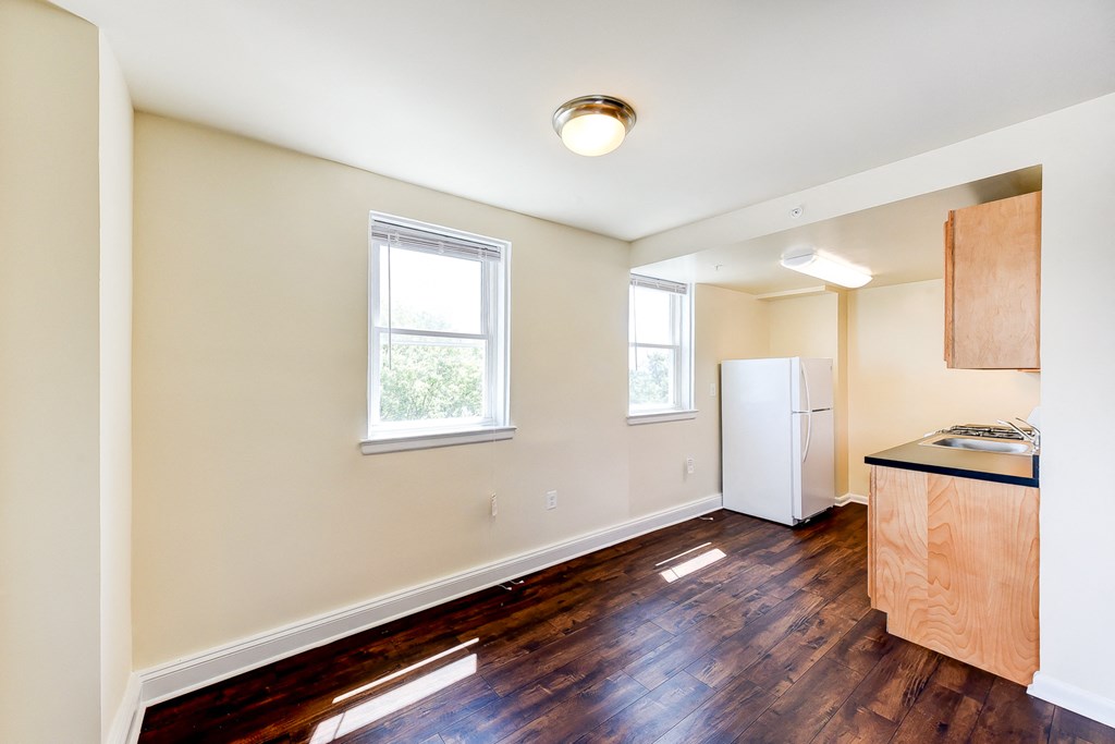 kitchen with hardwood floors, refrigerator and large windows at 734 longfellow street apartments in washington dc