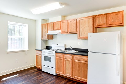a kitchen with wooden cabinets and white appliances