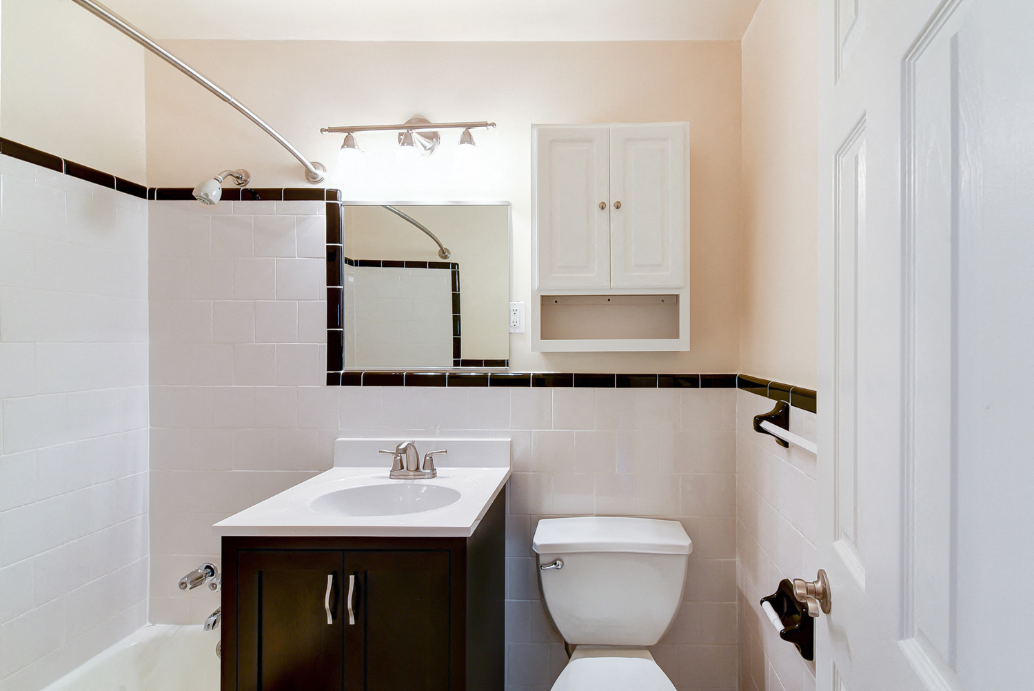 bathroom with tub, toilet, vanity, medicine cabinet and mirror at the norwood apartments in adams morgan washington dc