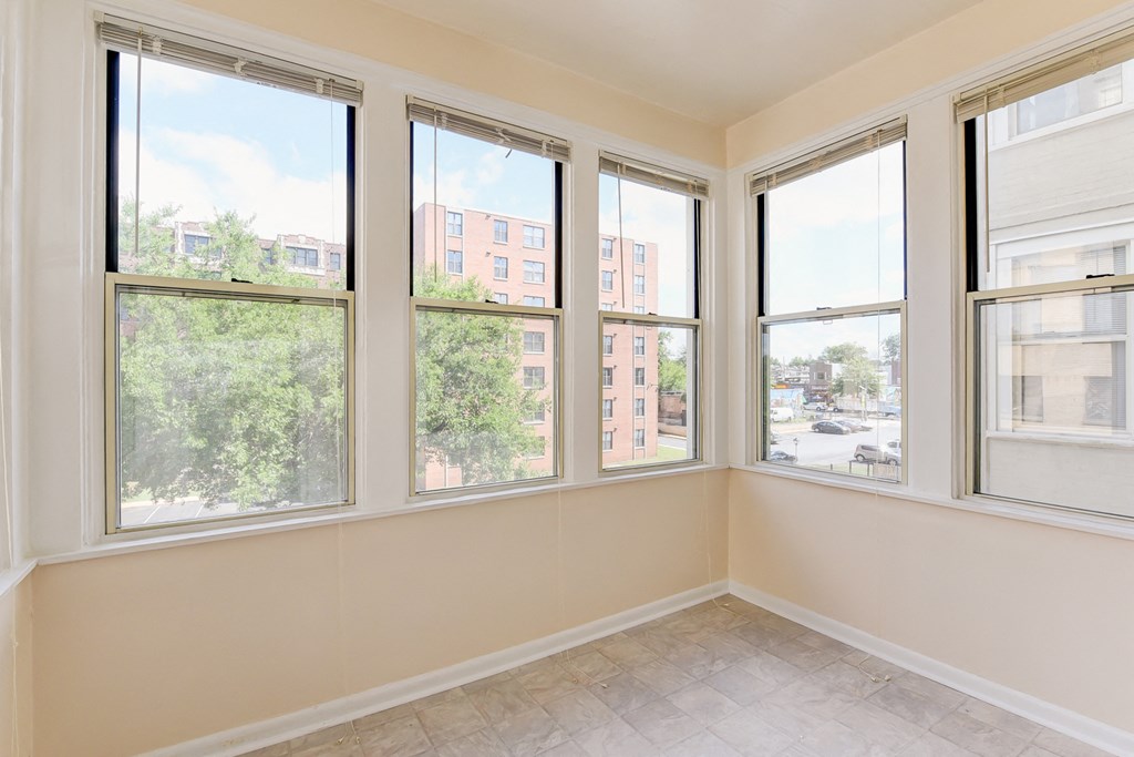 vacant sunroom with hardwood floors and large windows at twin oaks apartments columbia heights washington dc