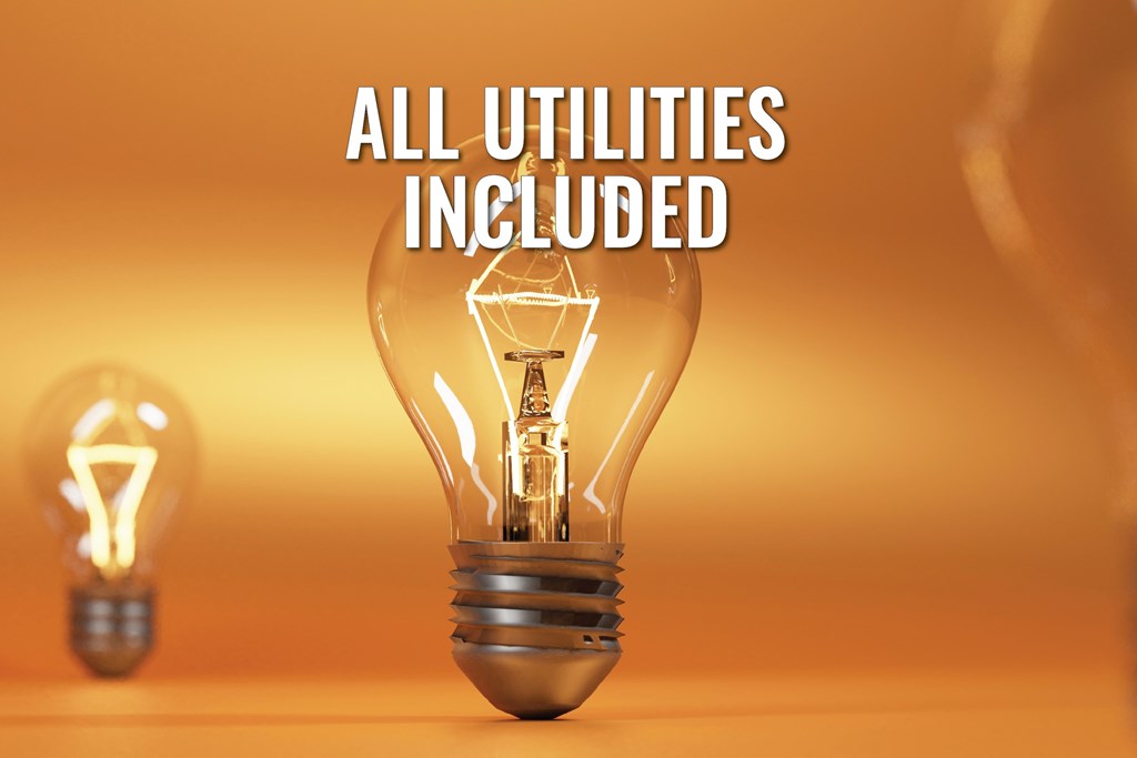A lit light bulb with the text "ALL UTILITIES INCLUDED" in front of it.