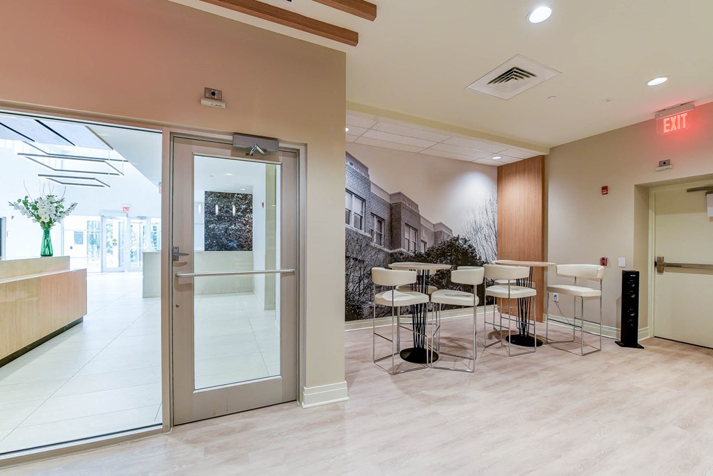 resident lounge with social seating and tables at archer park apartments in southeast Washington dc