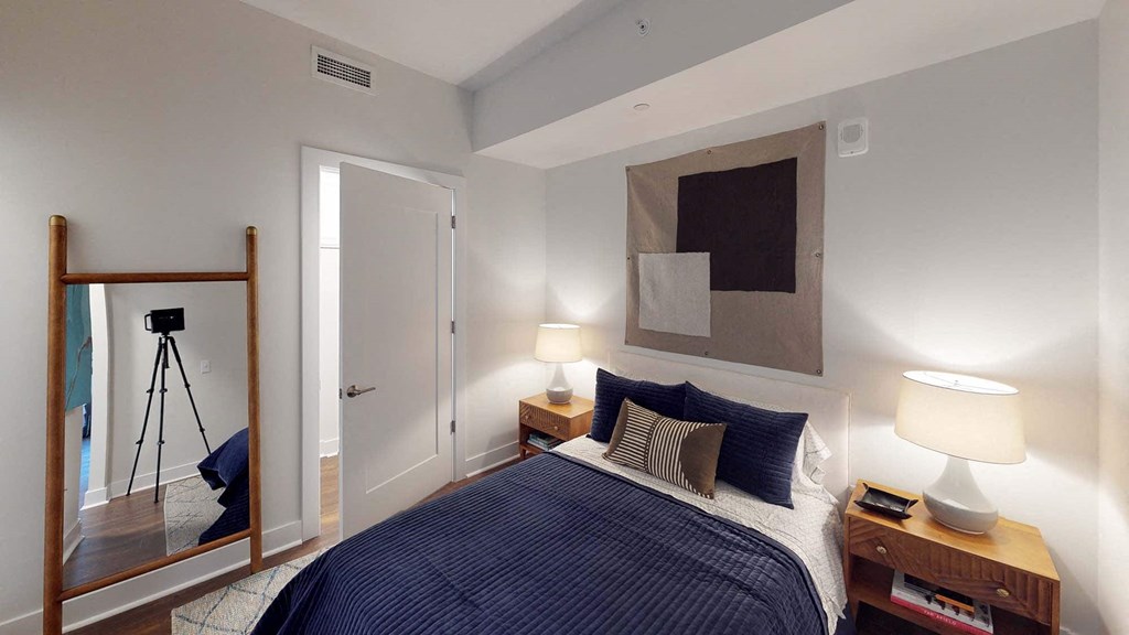 a bedroom with a bed and a mirror