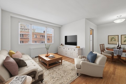 A living room with a couch, a coffee table, and a television.