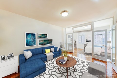 living area with sofa, coffee table, hardwood floors and view of bedroom at baystate apartments in washington dc
