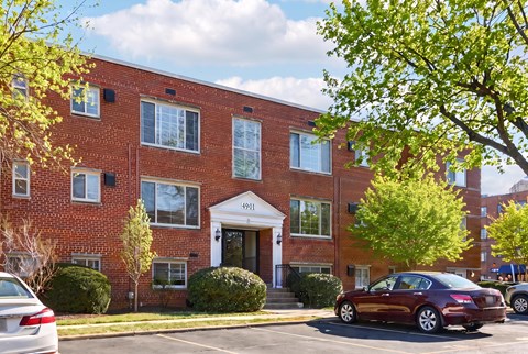 A red brick building with a white door and windows.
