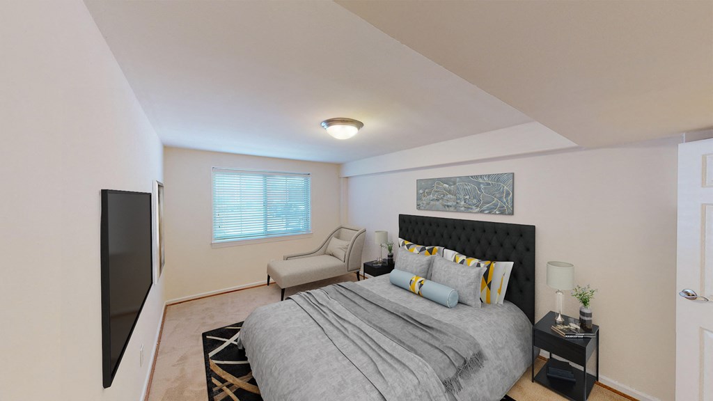 bedroom with bed, nightstands, large windows and tv at cambridge square apartments in bethesda md