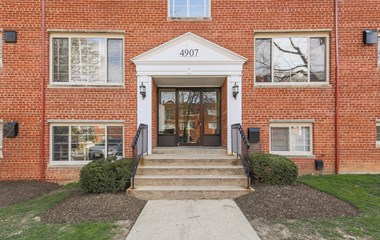 exterior entrance of brick apartments at cambridge square apartments in bethesda md