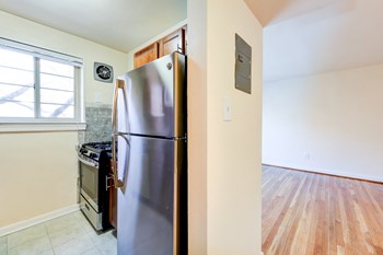 kitchen with stainless steel appliances and wood cabinetry at cambridge square apartments in bethesda md - Photo Gallery 4