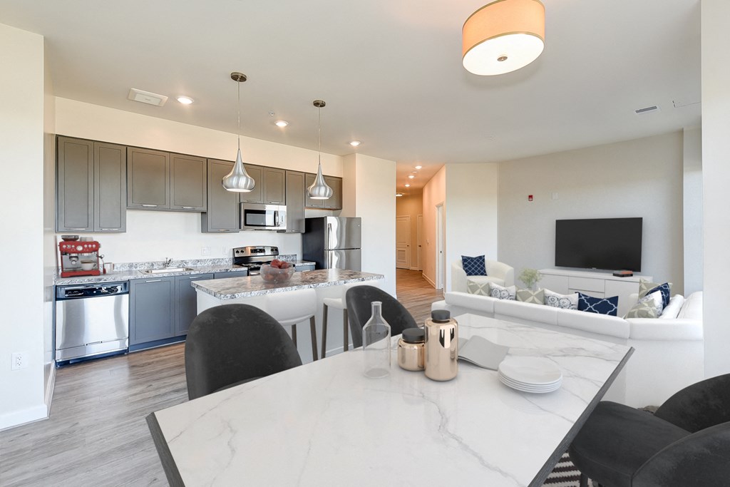 kitchen with stainless steel appliances, large breakfast bar and view of dining and living areas at city view apartments in washington dc