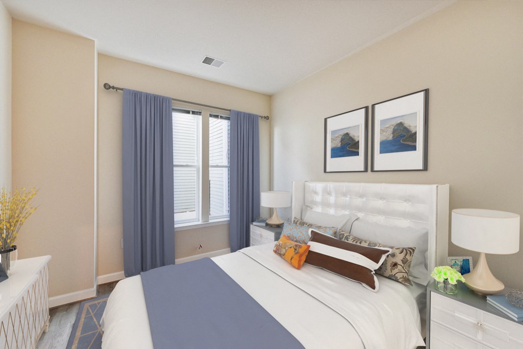 bedroom with bed, nightstands, large windows at city view apartments in washington dc