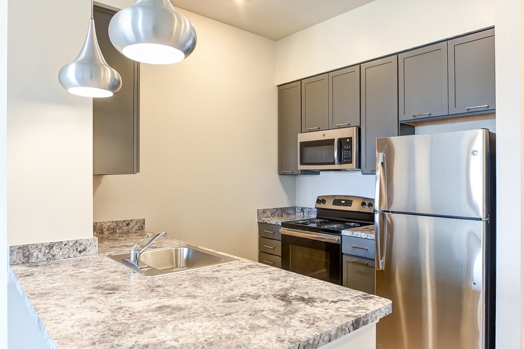kitchen with stainless steel appliances and large breakfast bar at city view apartments in washington dc