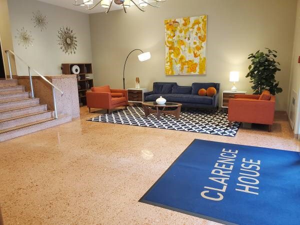 Clarence House is written on a blue mat in the middle of a room.