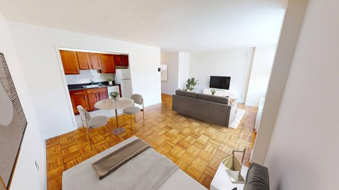 A living room with a grey couch and a white table.