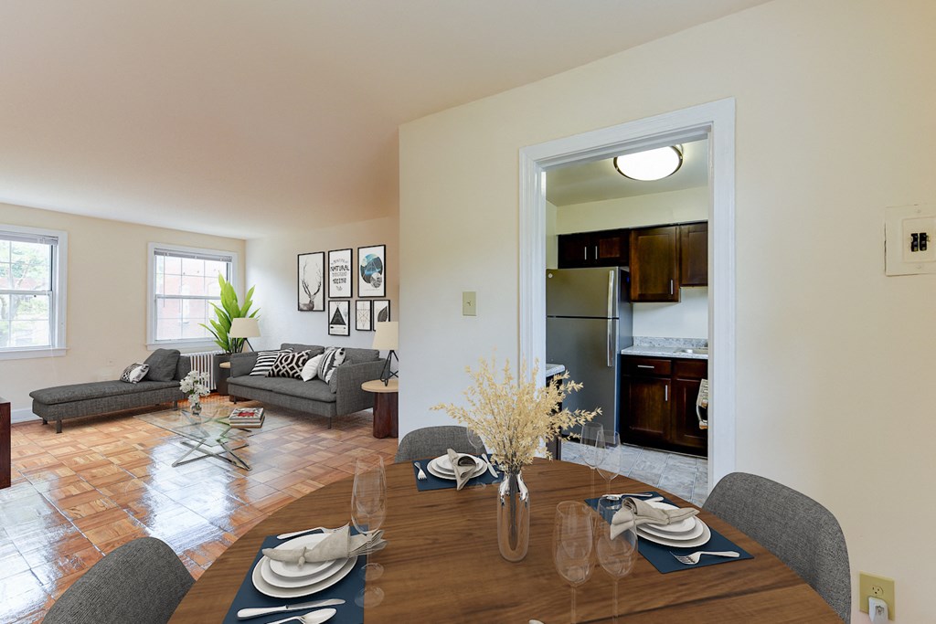 dining area with table, chairs, view of kitchen and living area at colonnade apartments in washington dc