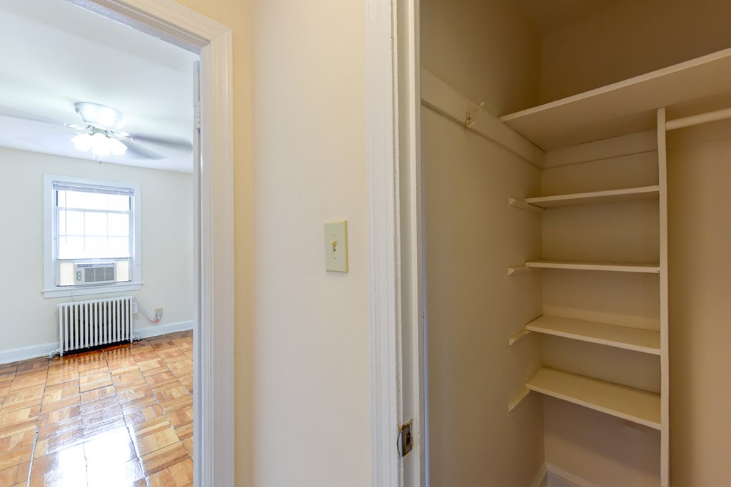 large closet with shelving and view of hallway at  colonnade apartments in washington dc