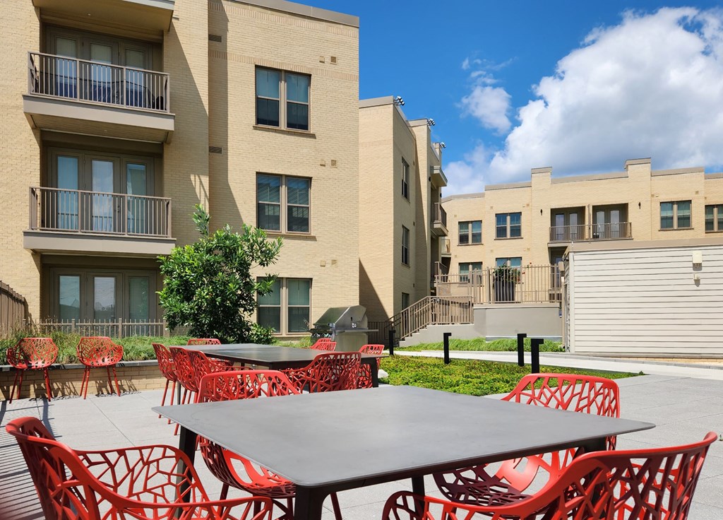 our apartments have a large patio with tables and chairs