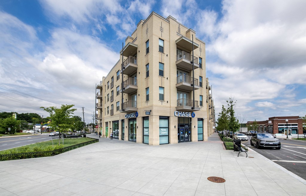an apartment building on the corner of a city street