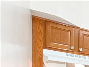 kitchen with oak cabinetry, tile flooring and white appliances at 1400 van buren apartments in washington dc - Photo Gallery 3