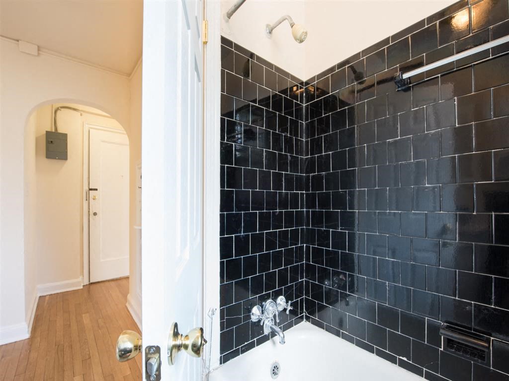 bathroom with tub and view of front entrance at 6100 14th Street apartments in washington dc