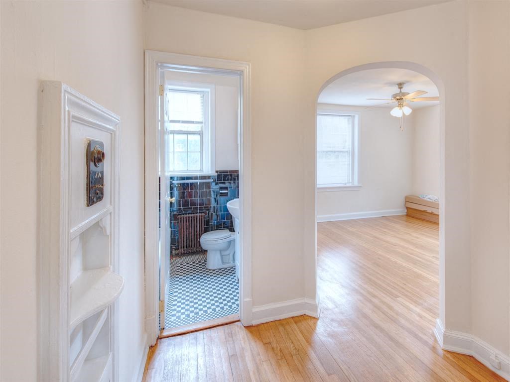 hallway view of bathroom and living area at 6100 14th Street apartments in washington dc