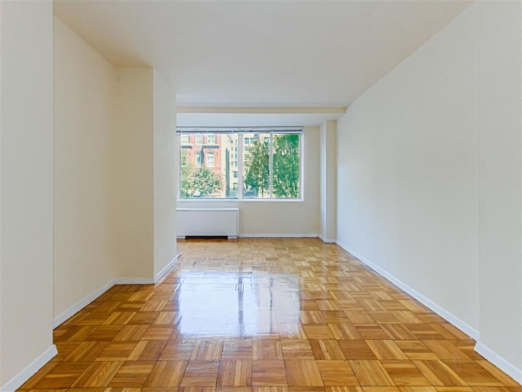 vacant apartment with hardwood flooring and large windows at brunswick house apartments in dupont circle washington dc