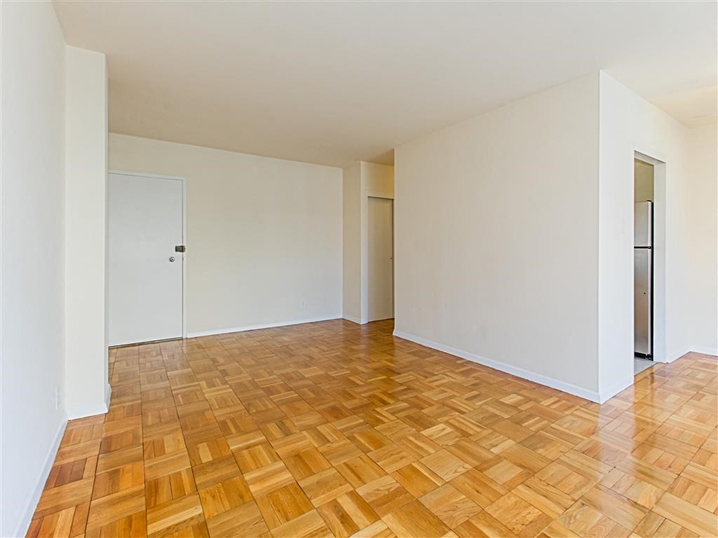 vacant apartment with hardwood flooring and view of front entrance at brunswick house apartments in dupont circle washington dc