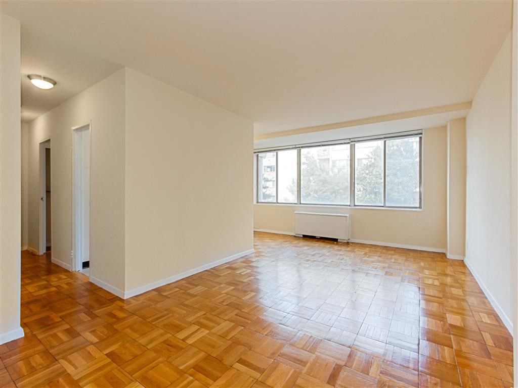 vacant apartment with hardwood flooring and large windows at brunswick house apartments in dupont circle washington dc