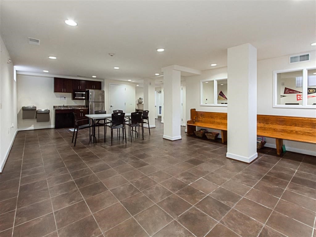 community room with social seating, tables and small kitchen at fairway park apartments in washington dc