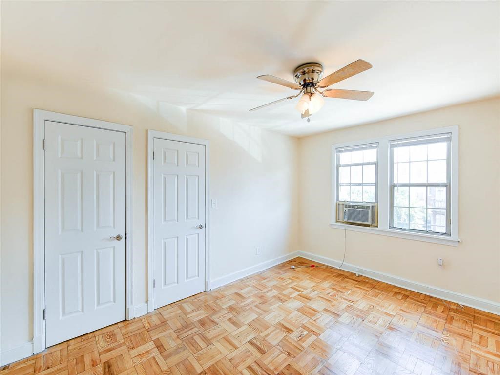 vacant bedroom with hardwood floors, large closets and windows at the meridian park apartments in columbia heights washington dc