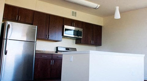 a kitchen with a refrigerator and a microwave