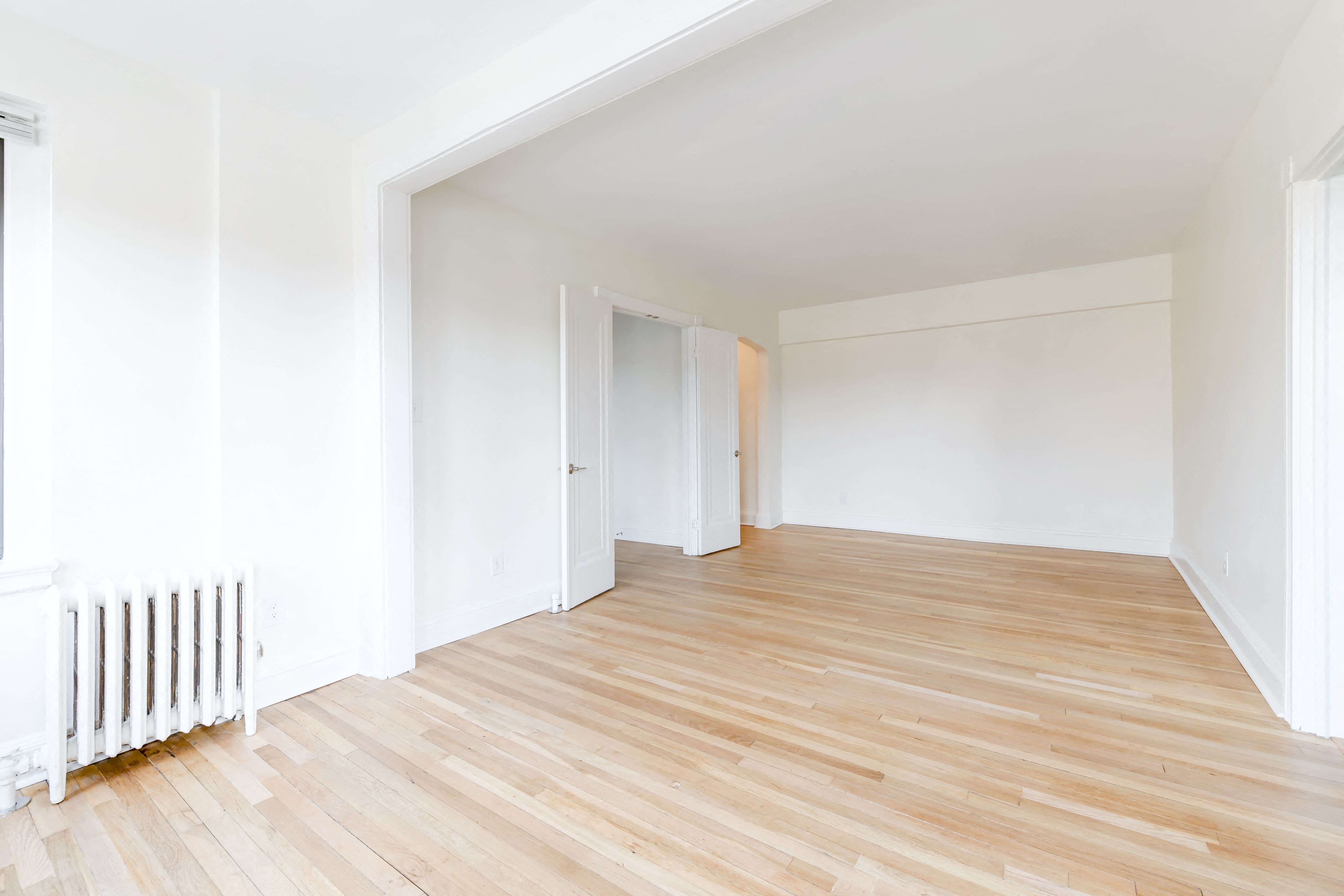 vacant living area with hardwood flooring at the dahlia apartments in washington dc