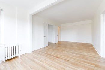 vacant living area with hardwood flooring at the dahlia apartments in washington dc - Photo Gallery 16