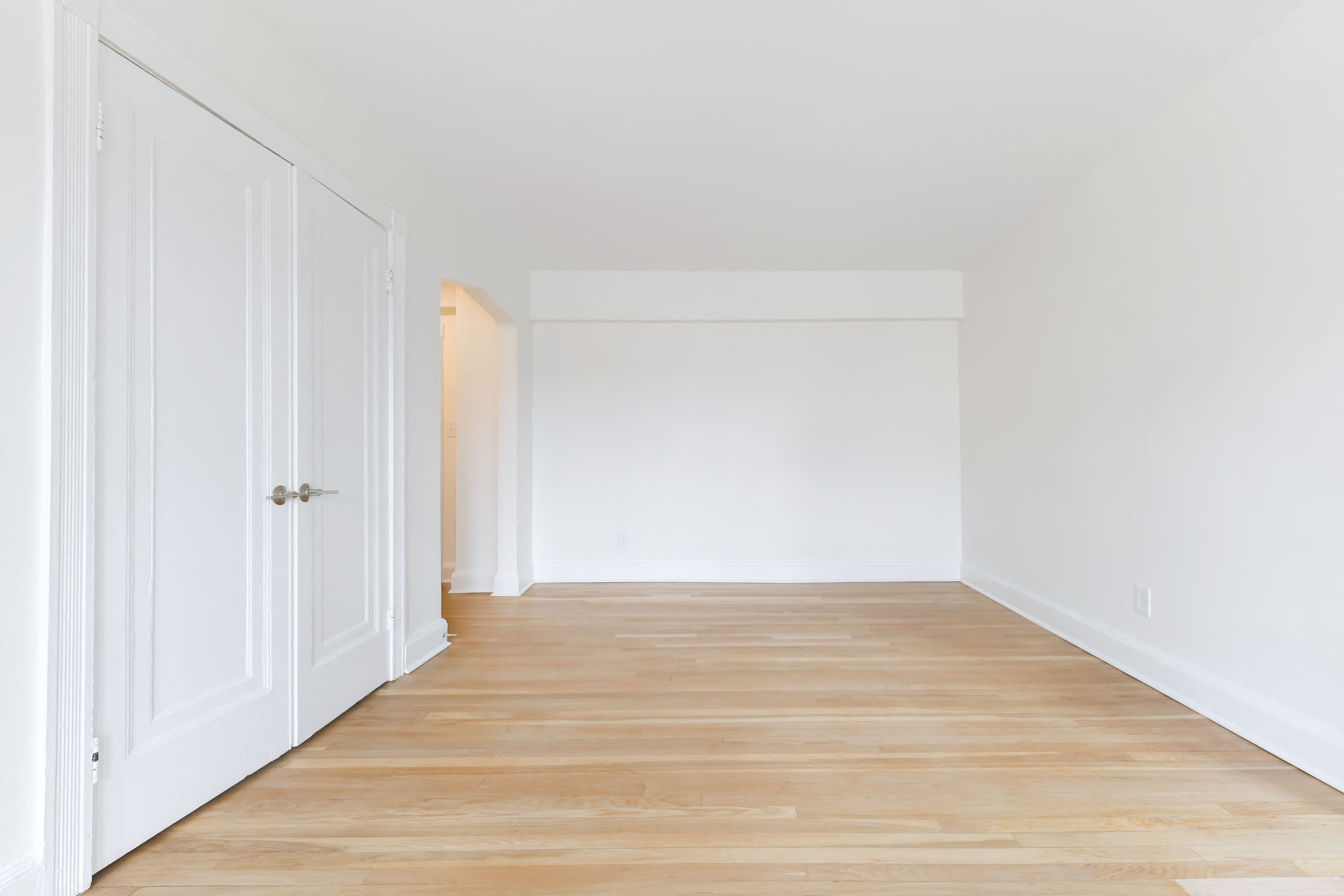 vacant bedroom with hardwood flooring at the dahlia apartments in washington dc