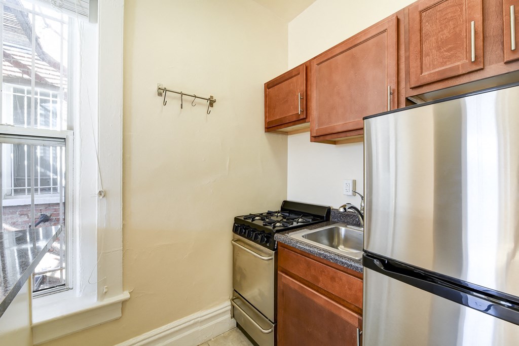 kitchen with stainless steel appliances and large window at dupont apartments in washington dc