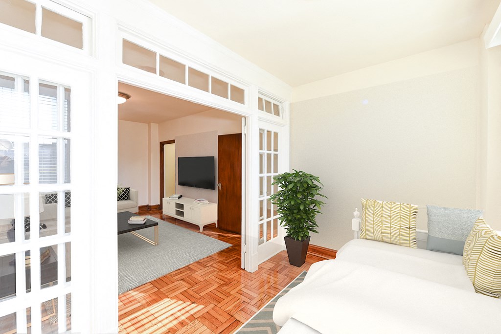 living area with sofa, coffee table, hardwood floors and view of sunroom at eddystone apartments in washington dc