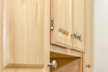 close of up oak wood kitchen cabinetry at fort totten apartments in washington dc - Photo Gallery 4