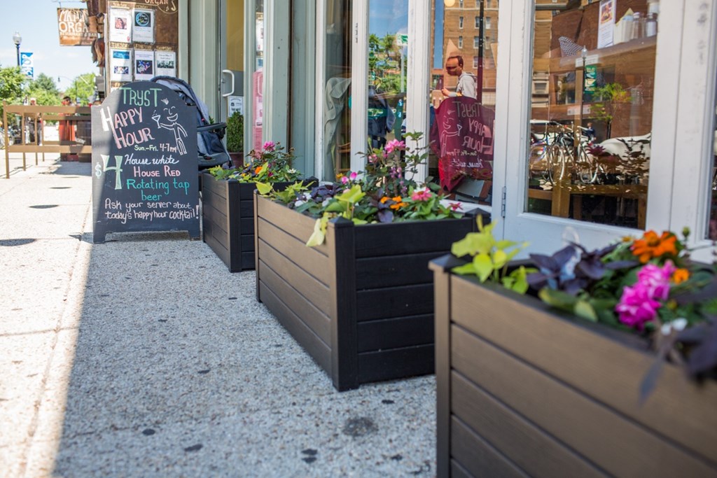 A sign outside a store that says "Try It Happy Hour".