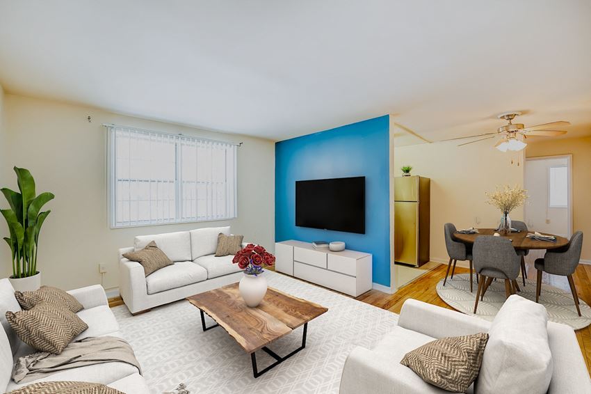 a living room with a blue accent wall and a white couch