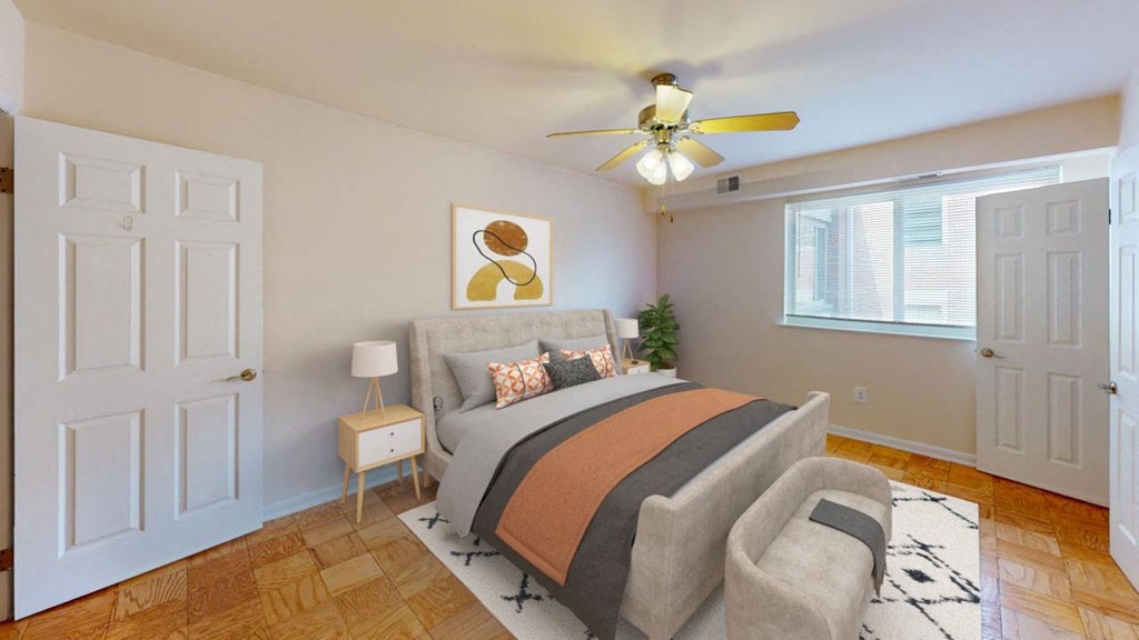 a bedroom with a bed and a ceiling fan at halley house apartments in washington dc