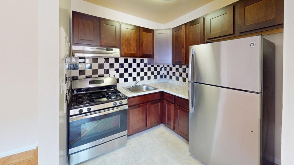a kitchen with stainless steel appliances and wooden cabinets