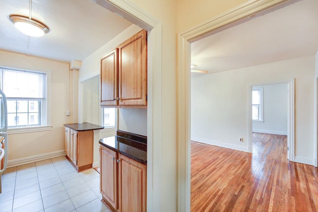 kitchen with view of living area and bedroom at hampton courts apartments in washington dc