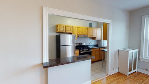 a kitchen with a counter top and a refrigerator