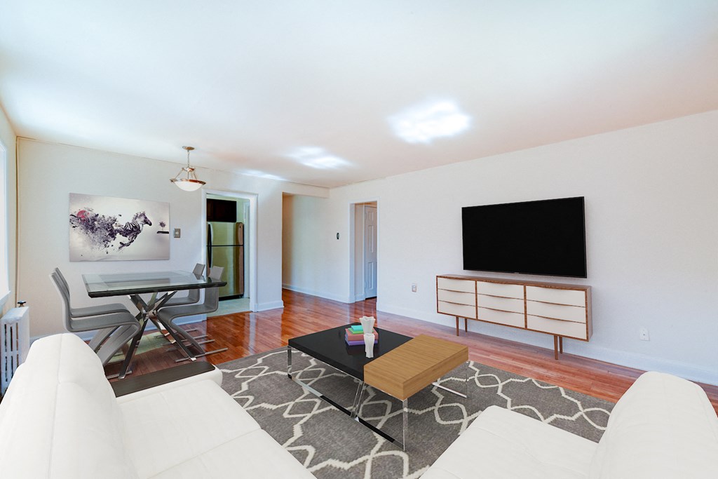living area with credenza, tv, sofa, coffee table, hardwood floors and view of dining area  at hillside terrace apartments in washington dc