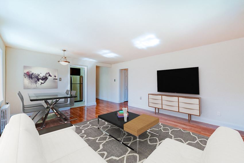 living area with credenza, tv, sofa, coffee table, hardwood floors and view of dining area at hillside terrace apartments in washington dc