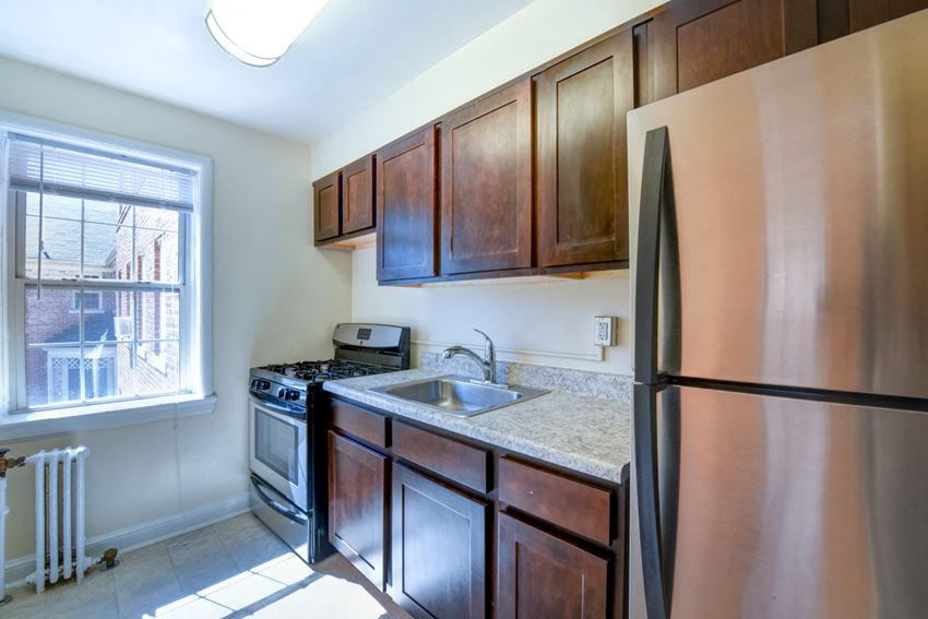 Hillside Terrace Apartments Renovated Kitchen kitchen with espresso cabinetry, stainless steel appliances and large window at hillside terrace apartments in washington dc