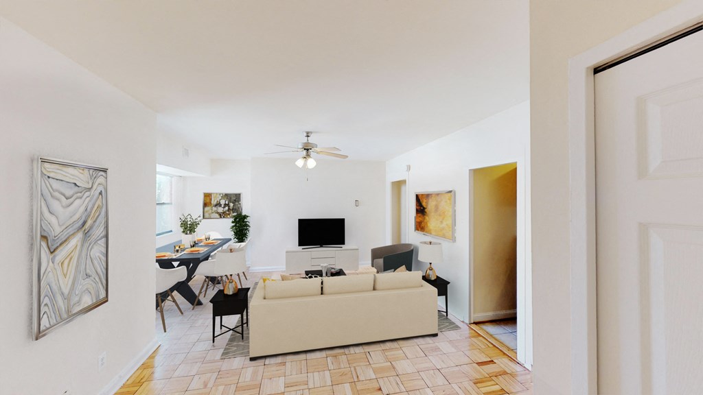 living area with sofa, dining area, tv, credenza, ceiling fan and hardwood flooring  at hilltop house apartments in columbia heights washington dc