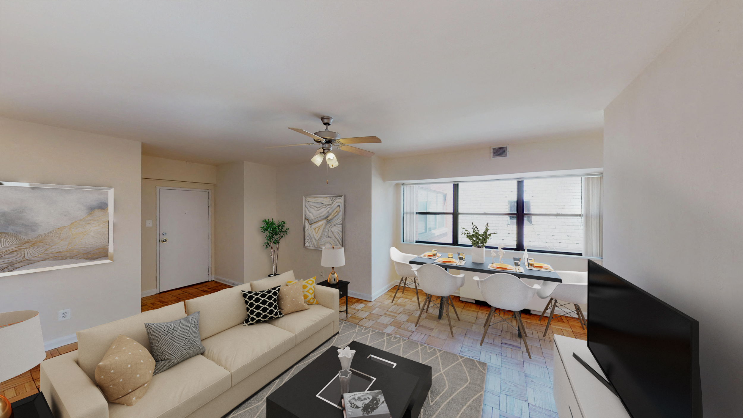 a living room with a white couch and a dining room table